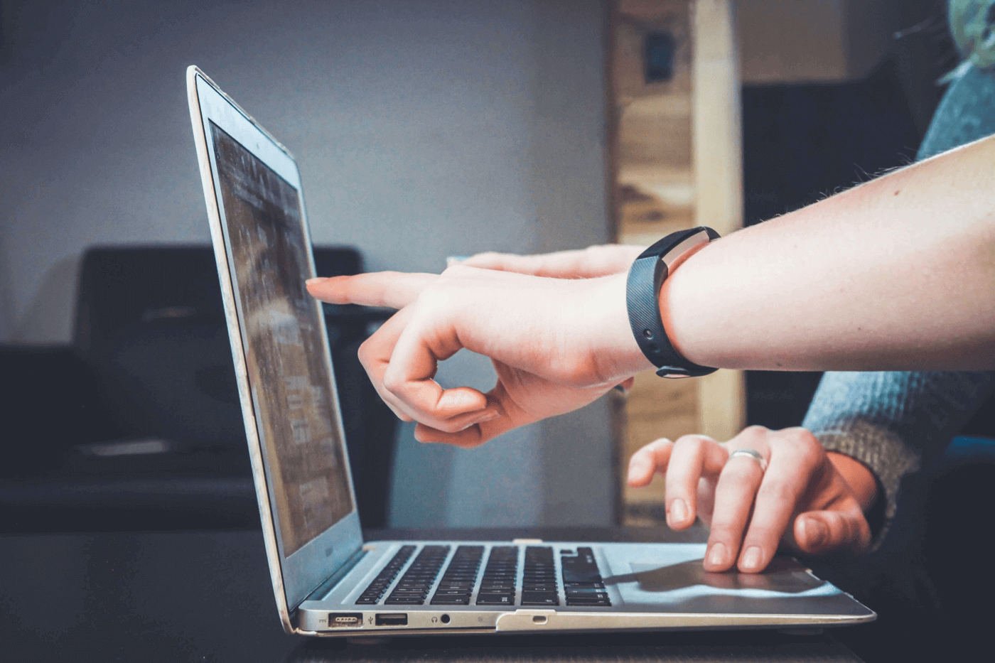 hand pointing at a computer